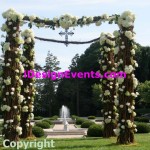 Floral wedding arch in a garden setting.