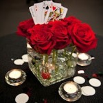 Roses in a vase with playing cards.
